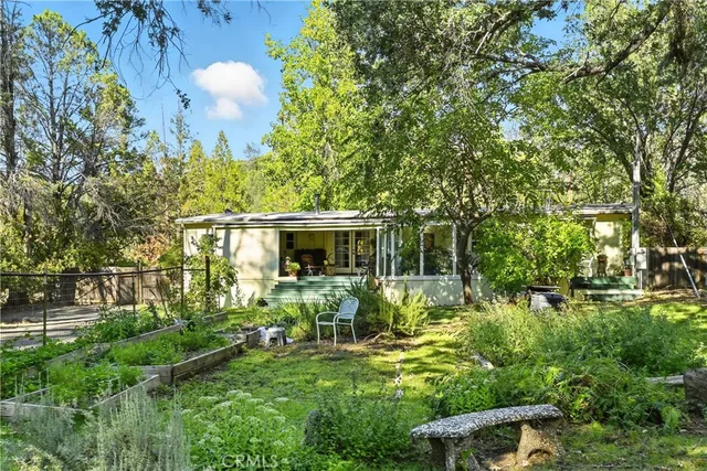 a view of backyard of house with green space