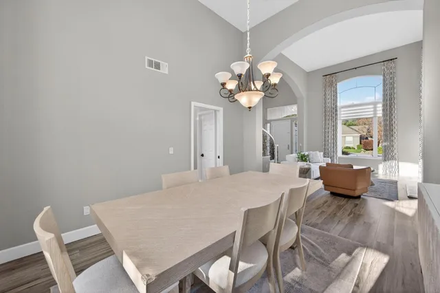 a view of a dining room with furniture wooden floor and chandelier
