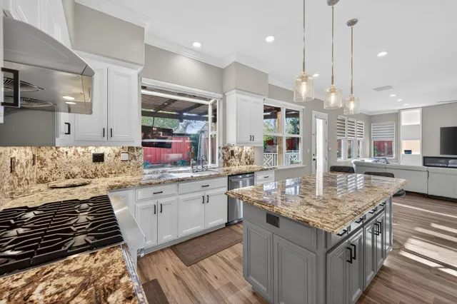 a kitchen with stainless steel appliances granite countertop a stove and a sink