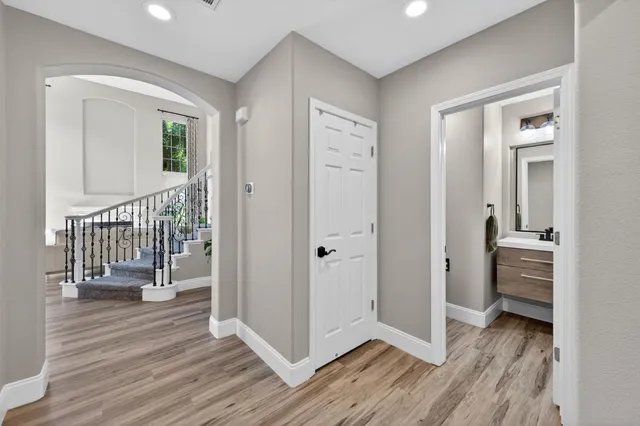 a view of a hallway with the wooden floor and entryway