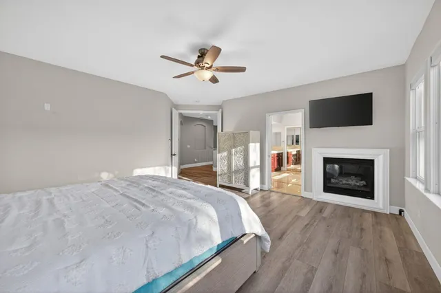 a spacious bedroom with a bed and a fireplace