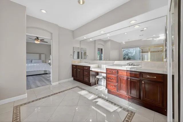 a large bathroom with a double vanity sink and a mirror
