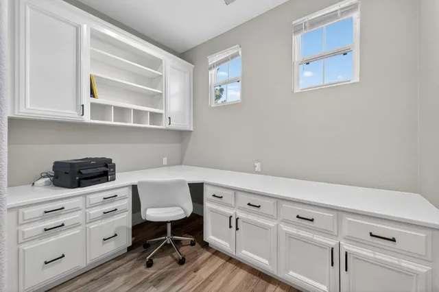 a kitchen with white cabinets and white appliances