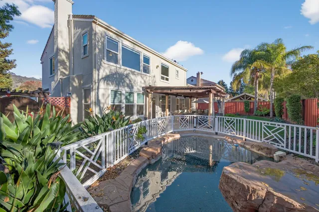a view of a house with porch and garden