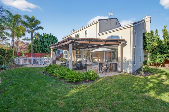 a view of a chairs and table in patio with a backyard