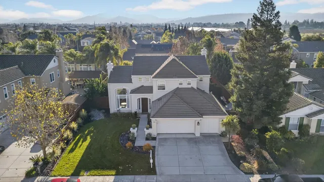 an aerial view of a house with a yard and garden