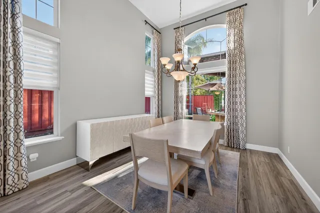a view of a dining room with furniture and a window