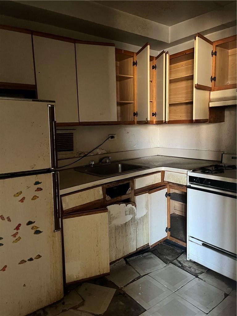 1020 Grand Concourse, Unit 8H Bronx, NY 10451 - Photo 6 of 13 Kitchen with sink, fridge, tile patterned floors, stove, and range hood