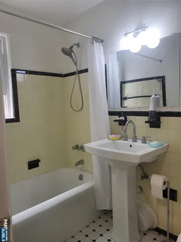 a bathroom with a sink a mirror and a bathtub