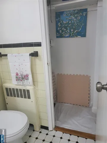 a white toilet sitting next to a shower curtain