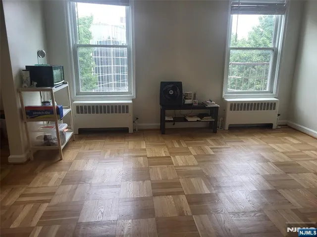 a view of a livingroom with furniture and a window