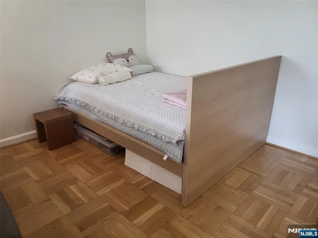 a bedroom with a bed and a white cabinet