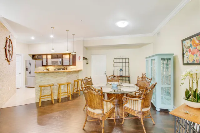 a dining room with furniture and wooden floor