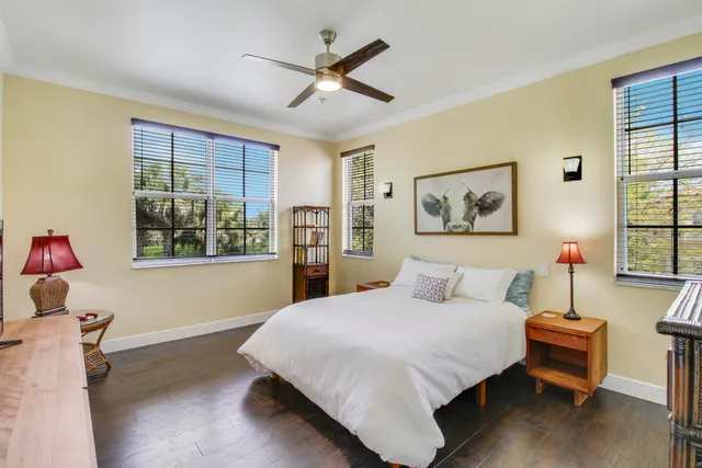 a bathroom with a granite countertop sink a toilet a mirror a bathtub and shower