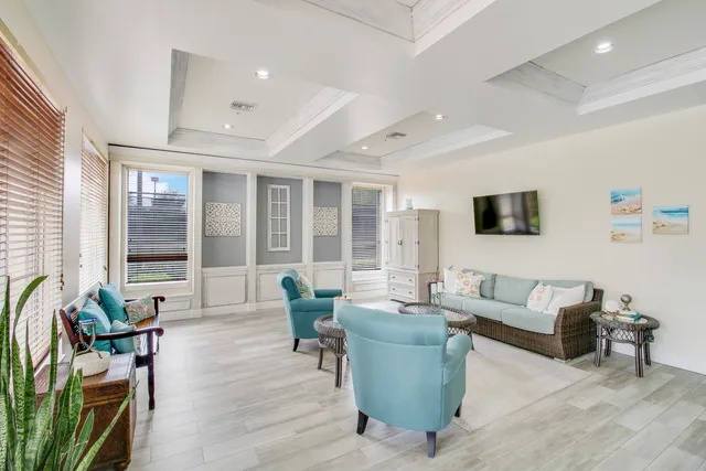 a dining room with furniture potted plants and wooden floor