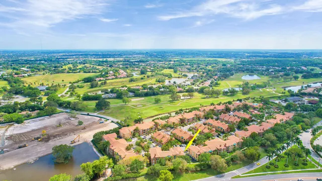 an aerial view of residential building and lake