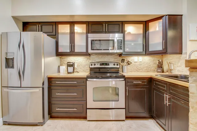 a view of a kitchen with a sink and cabinets
