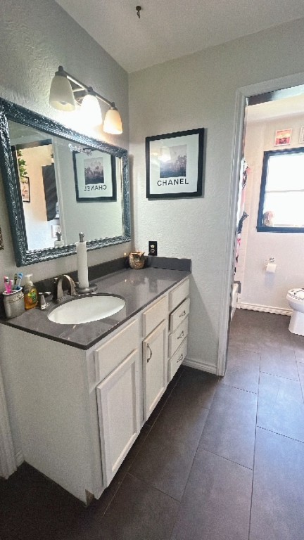 319 Walnut Avenue Winnie, TX 77665 - Photo 12 of 19 a spacious bathroom with a granite countertop sink a mirror and a toilet