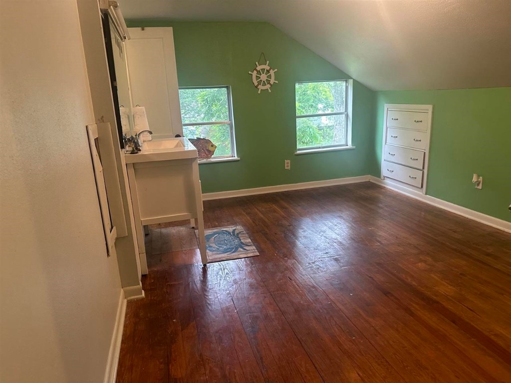 319 Walnut Avenue Winnie, TX 77665 - Photo 15 of 19 a view of empty room with wooden floor and fan