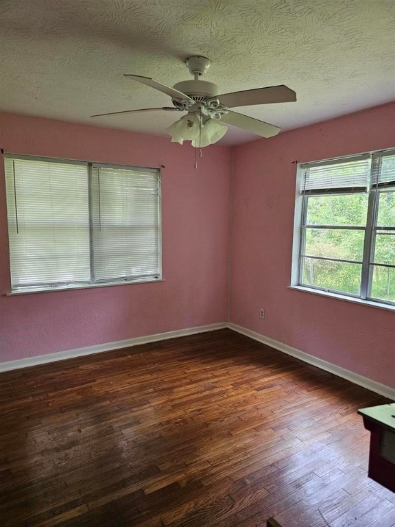 319 Walnut Avenue Winnie, TX 77665 - Photo 16 of 19 a view of a room with window a ceiling fan and wooden floor
