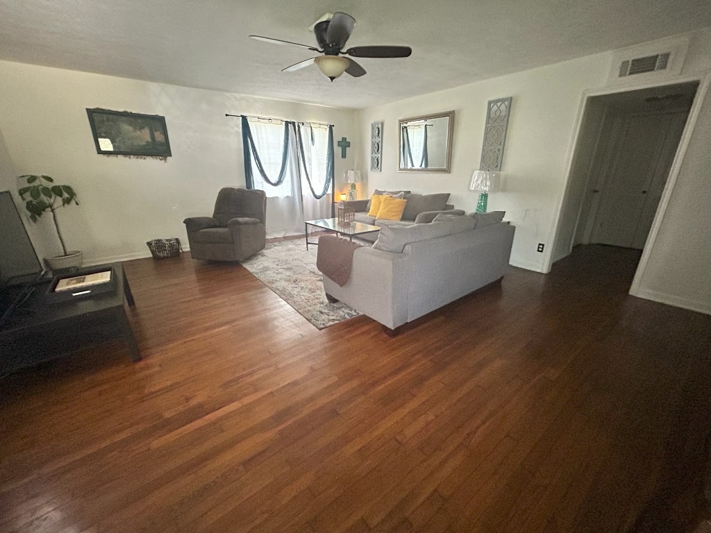 319 Walnut Avenue Winnie, TX 77665 - Photo 2 of 19 a living room with furniture and a wooden floor