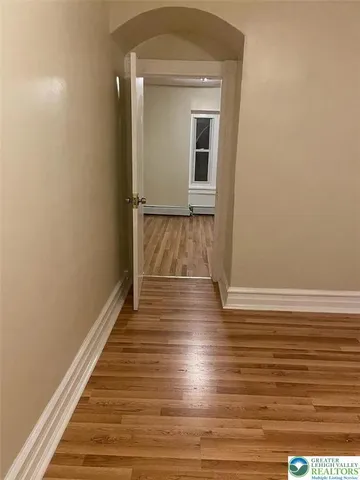 a view of a room with wooden floor