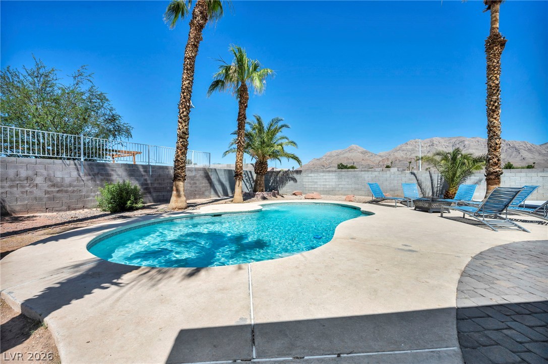 5882 Rio Tinto Way Las Vegas, NV 89110 - Photo 41 of 56 An inviting backyard oasis offers a free-form pool and ample patio space for leisure under the desert sky.