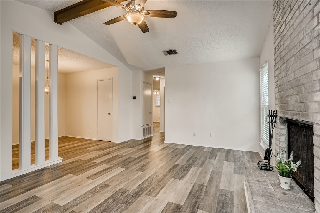 wooden floor in an empty room with a fireplace