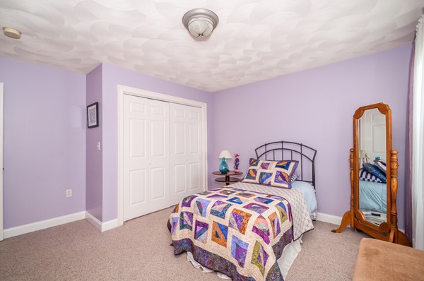 100 Eastgate Road Tewksbury, MA 01876 - Photo 21 of 30 a bedroom with a bed and a chandelier