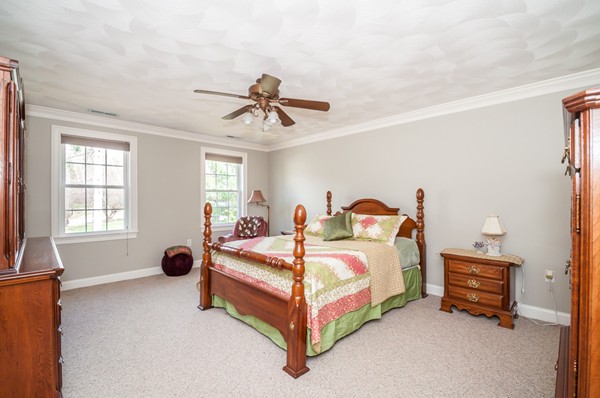 100 Eastgate Road Tewksbury, MA 01876 - Photo 25 of 30 a spacious bedroom with a bed and a chandelier