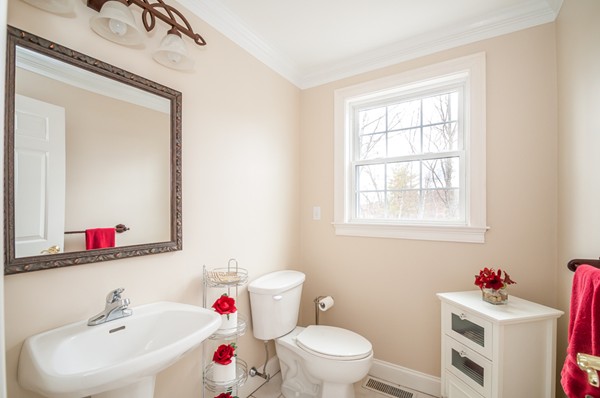 100 Eastgate Road Tewksbury, MA 01876 - Photo 7 of 30 a white toilet sitting next to a bathroom sink
