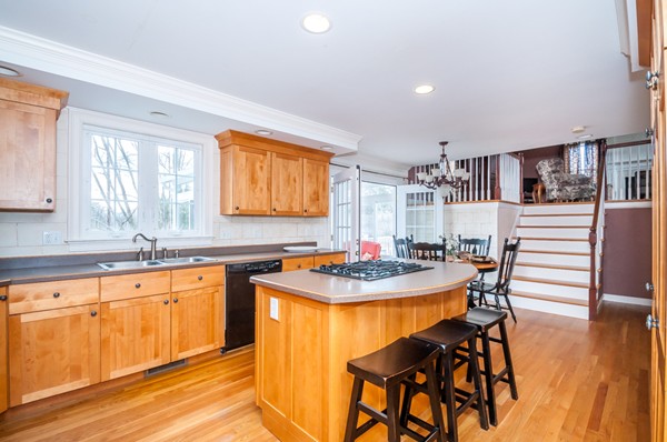 100 Eastgate Road Tewksbury, MA 01876 - Photo 8 of 30 a kitchen with a table chairs stove and cabinets