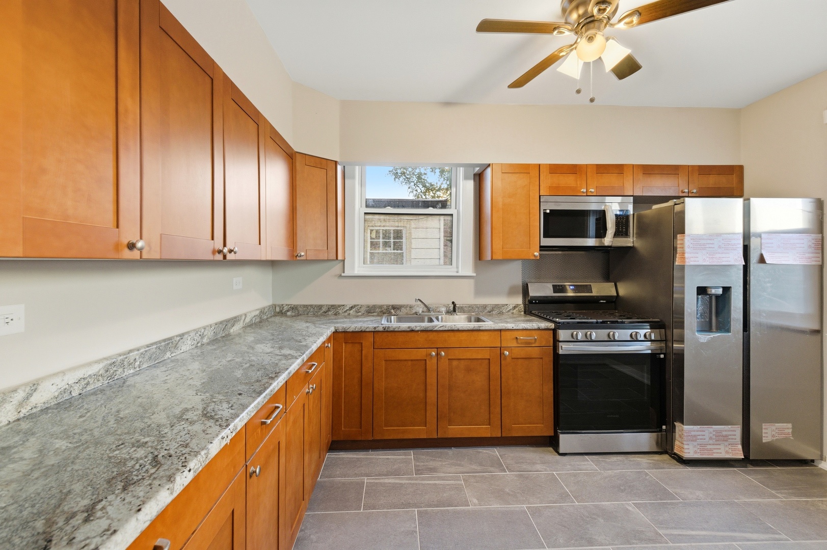8344 South Marshfield Avenue Chicago, IL 60620 - Photo 11 of 35 a kitchen with stainless steel appliances granite countertop a sink and a refrigerator