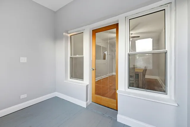 an empty room with windows and closet