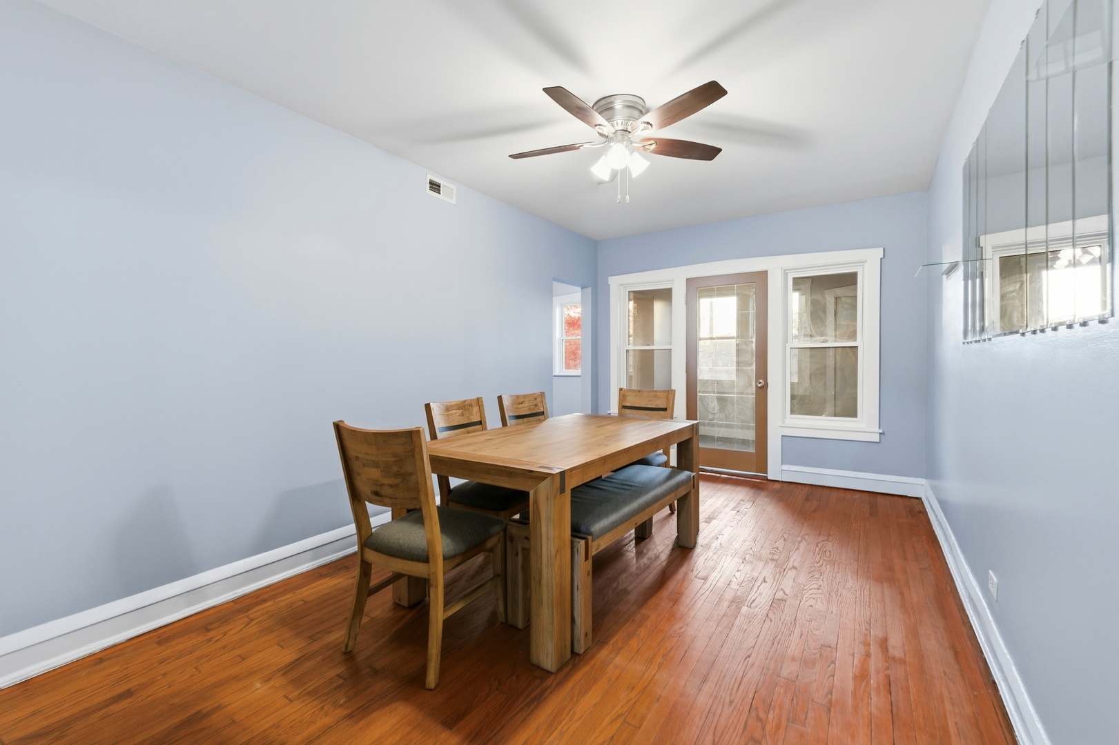 8344 South Marshfield Avenue Chicago, IL 60620 - Photo 16 of 35 a living room with a table chairs and wooden floor
