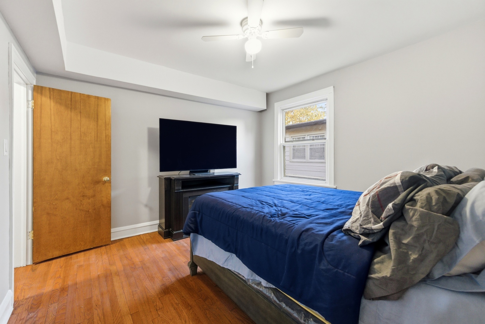 8344 South Marshfield Avenue Chicago, IL 60620 - Photo 21 of 35 a bedroom with a bed and a flat screen tv