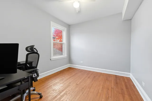 a view of a workspace with furniture and a window