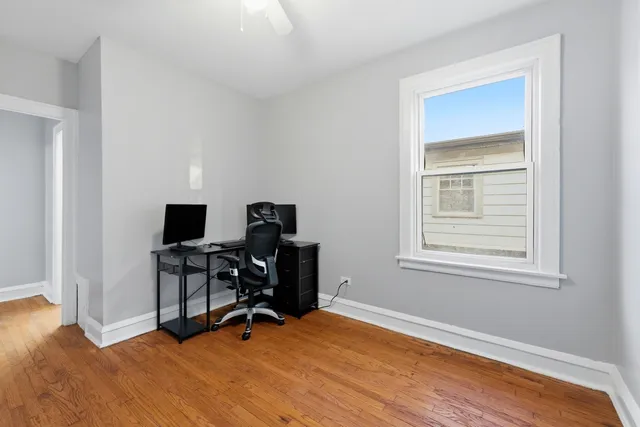 a view of workspace with wooden floor and windows