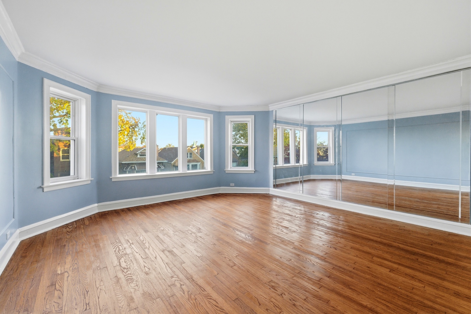 8344 South Marshfield Avenue Chicago, IL 60620 - Photo 3 of 35 a view of an empty room with wooden floor and a window