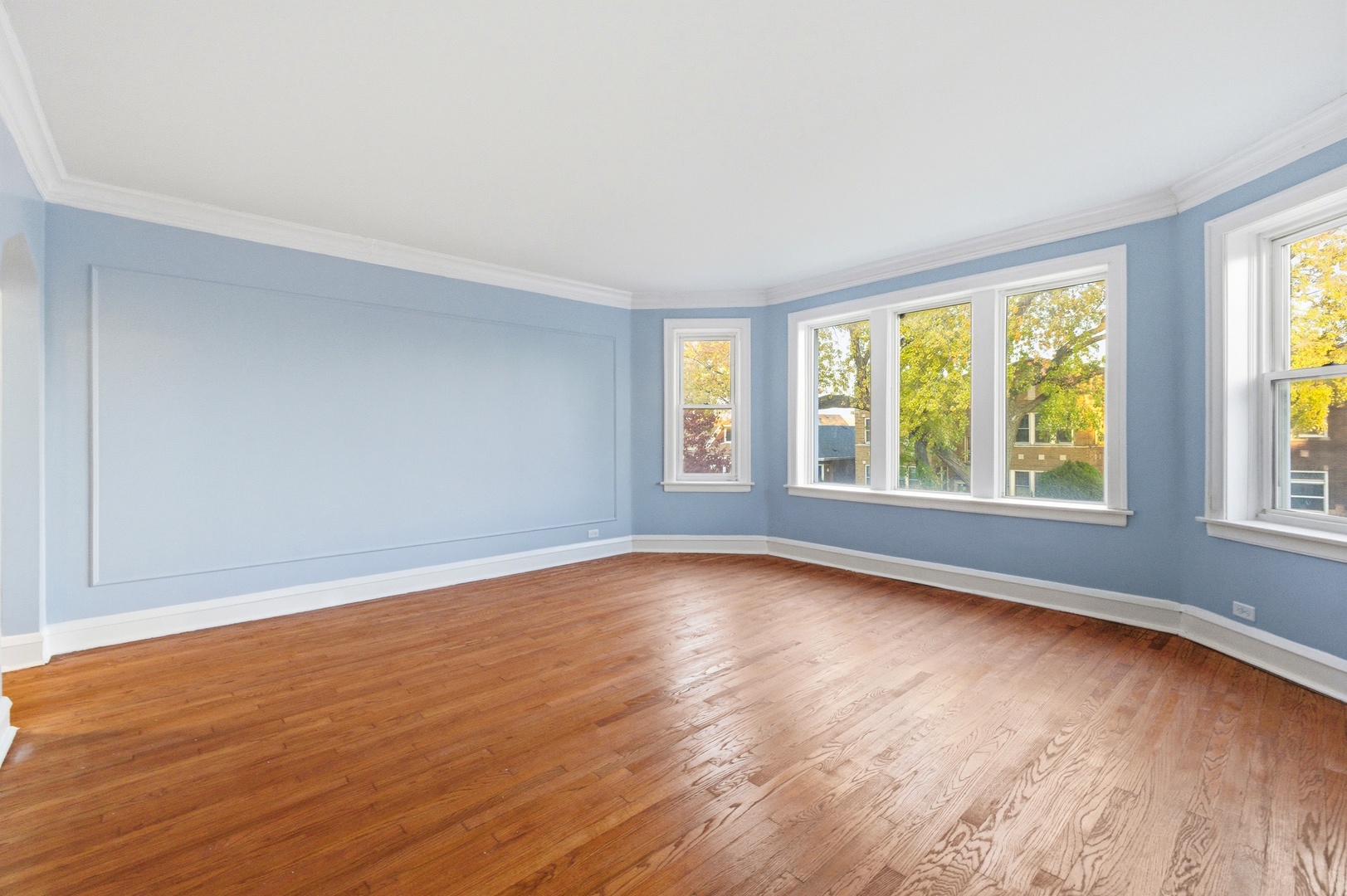 8344 South Marshfield Avenue Chicago, IL 60620 - Photo 4 of 35 a view of an empty room with wooden floor and a window