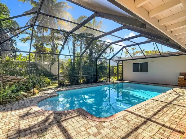 a view of a backyard with a small deck and a lounge chair
