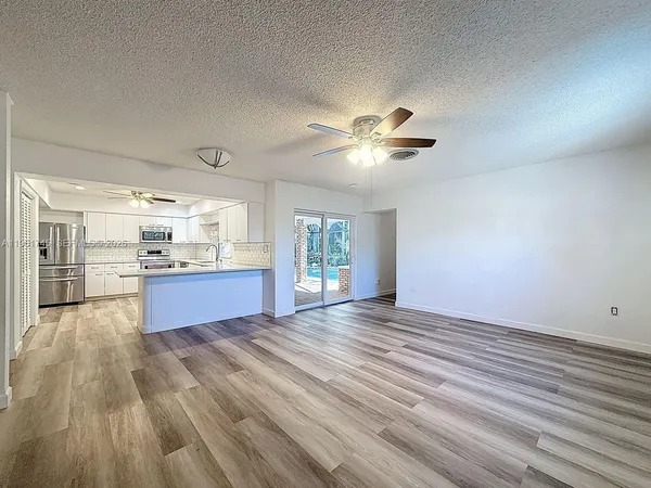a view of kitchen with sink and wooden floor