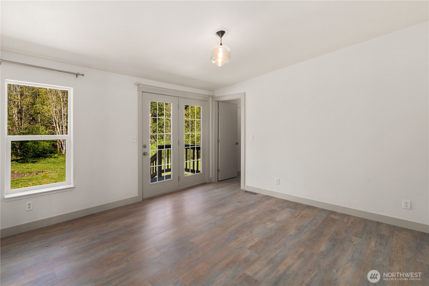 408 South Saylor Road Camano Island, WA 98282 - Photo 12 of 38 an empty room with wooden floor and windows