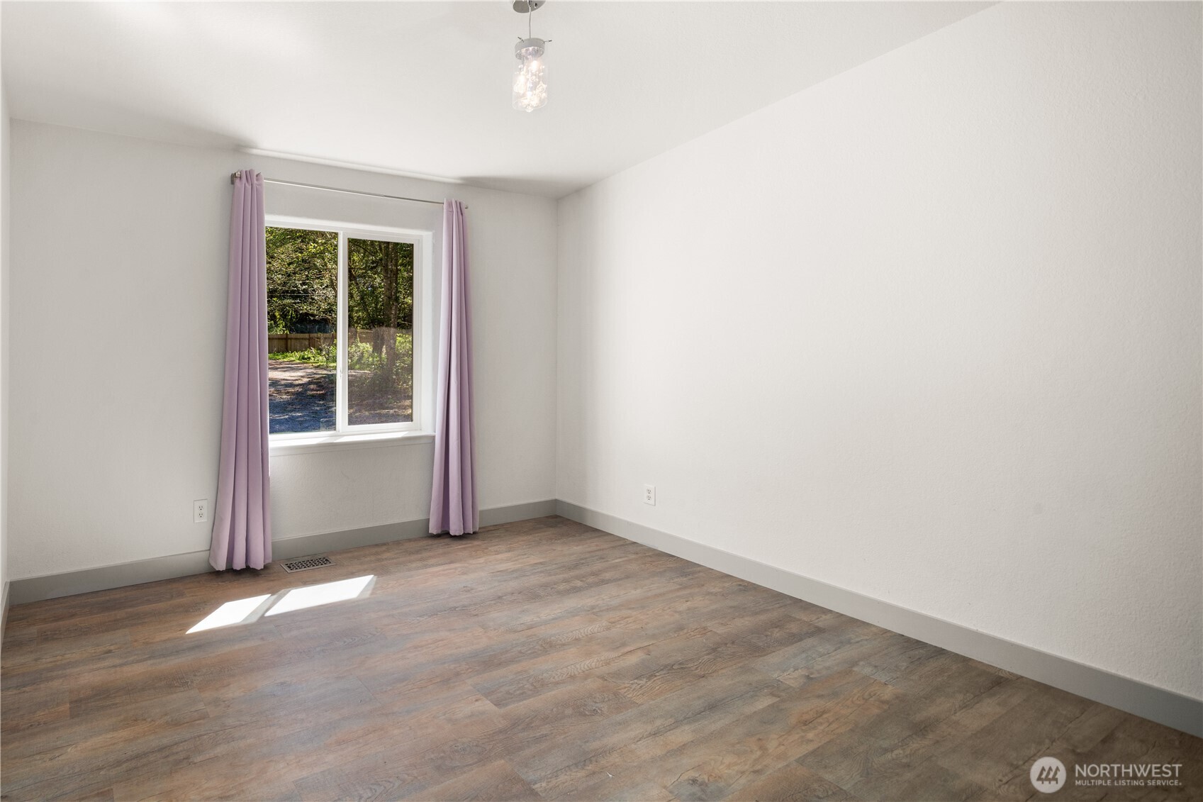 408 South Saylor Road Camano Island, WA 98282 - Photo 22 of 38 an empty room with wooden floor and windows