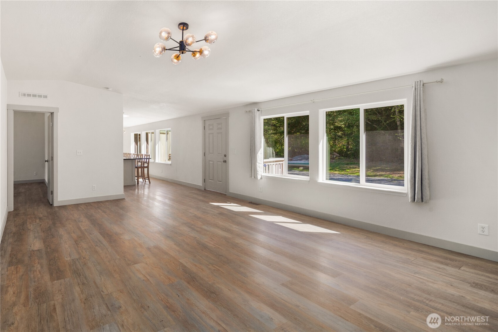 408 South Saylor Road Camano Island, WA 98282 - Photo 5 of 38 a view of an empty room with a window and wooden floor