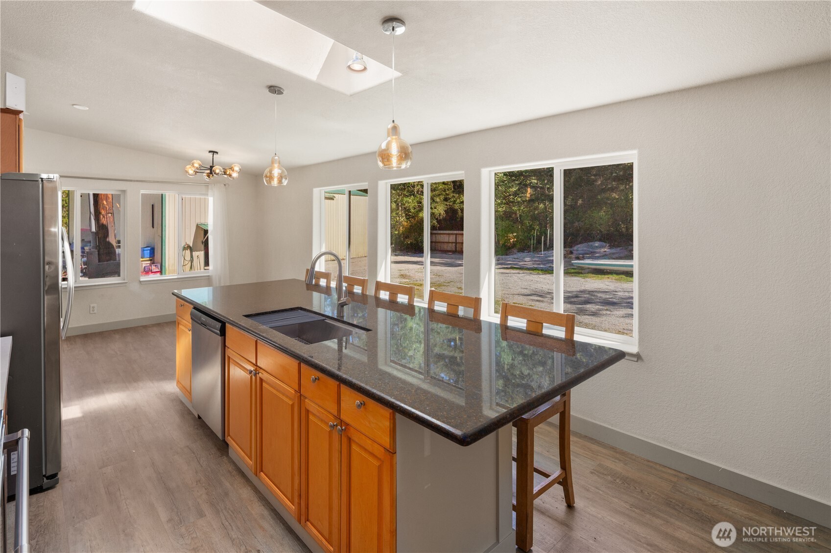 408 South Saylor Road Camano Island, WA 98282 - Photo 7 of 38 a kitchen with stainless steel appliances granite countertop a sink stove and wooden floor