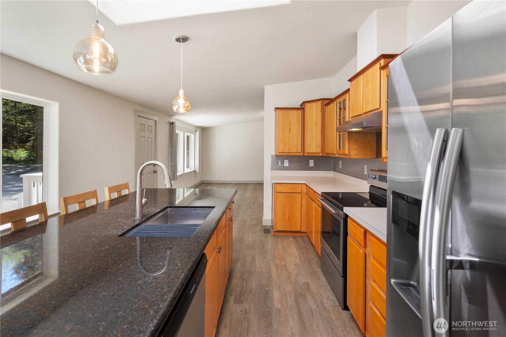 408 South Saylor Road Camano Island, WA 98282 - Photo 8 of 38 a kitchen with stainless steel appliances granite countertop a sink a stove and refrigerator