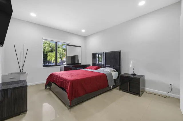 a spacious bedroom with a bed and window