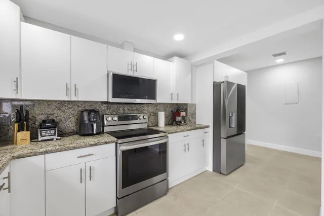 a kitchen with stainless steel appliances a refrigerator stove and microwave