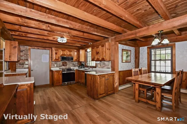 a large kitchen with a table and chairs